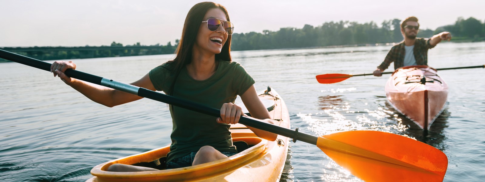 woman and man kayaking and smiling