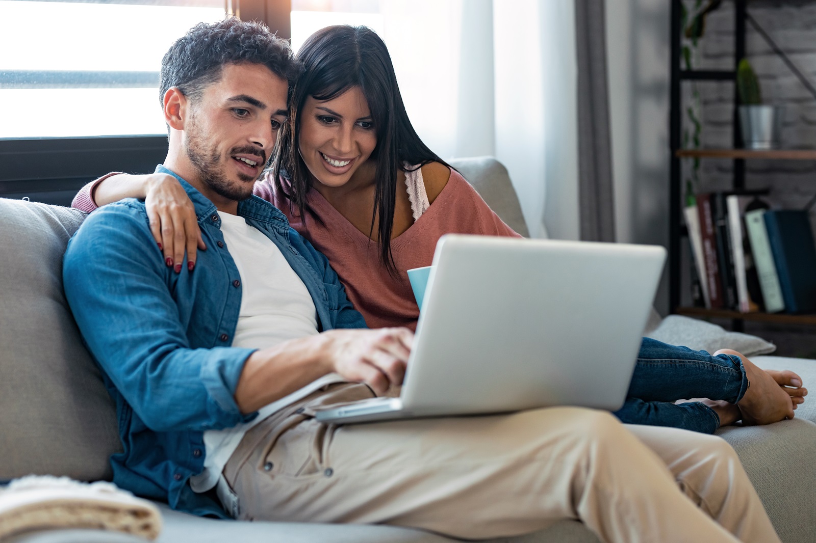 Young couple excitedly learning about becoming CHOME FCU members.