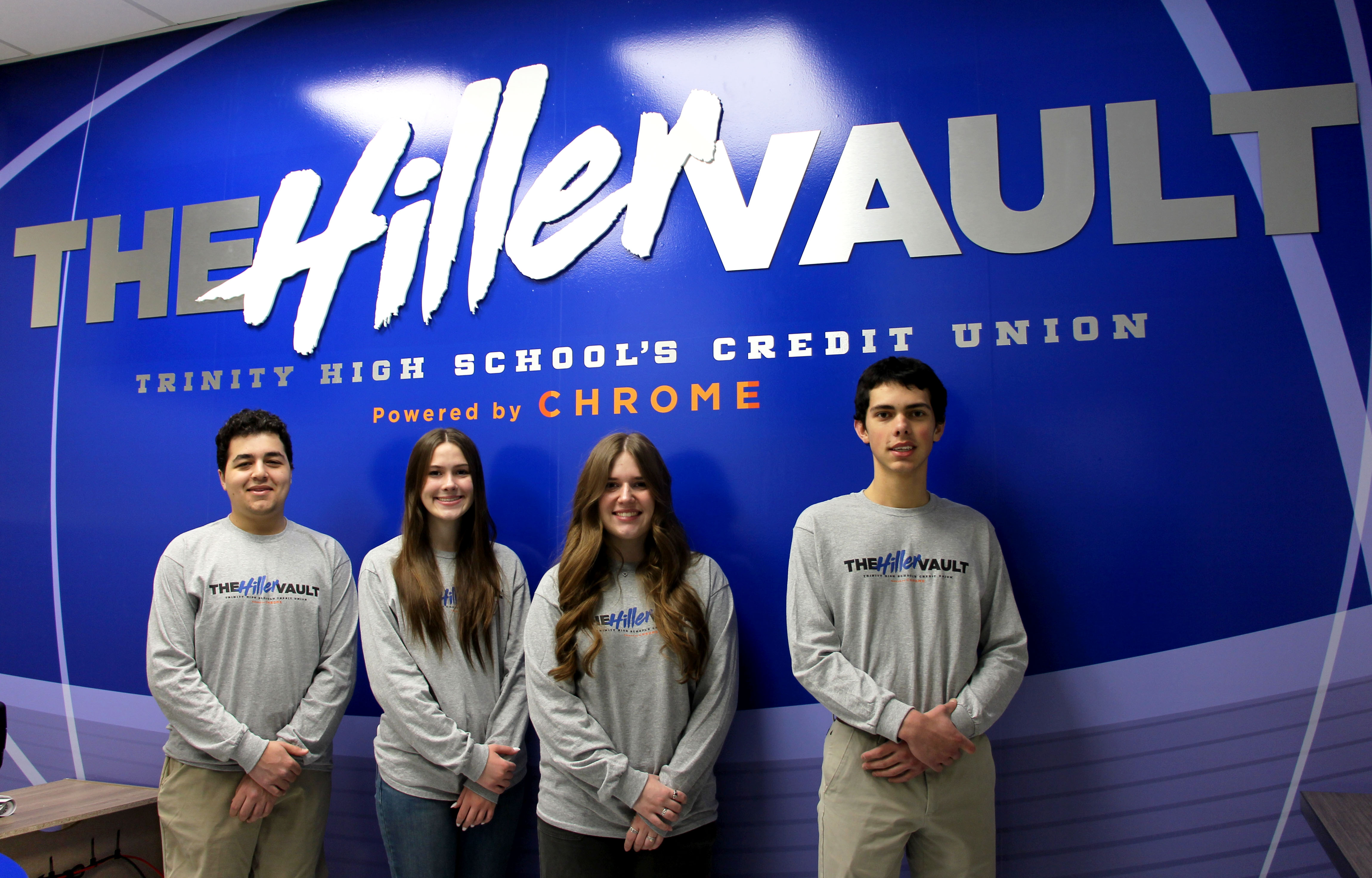 4 Trinity students standing in front of the trinity branch 